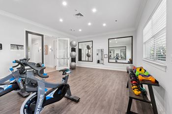 Yoga room with cycling studio and fitness mirror